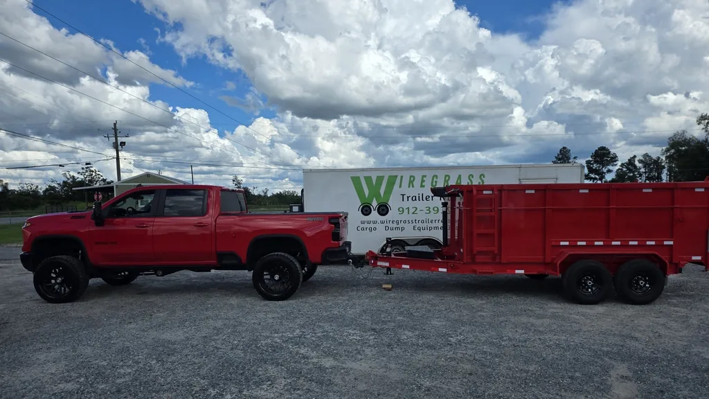 Southern Landscape Delivery pickup truck towing a red dumpster